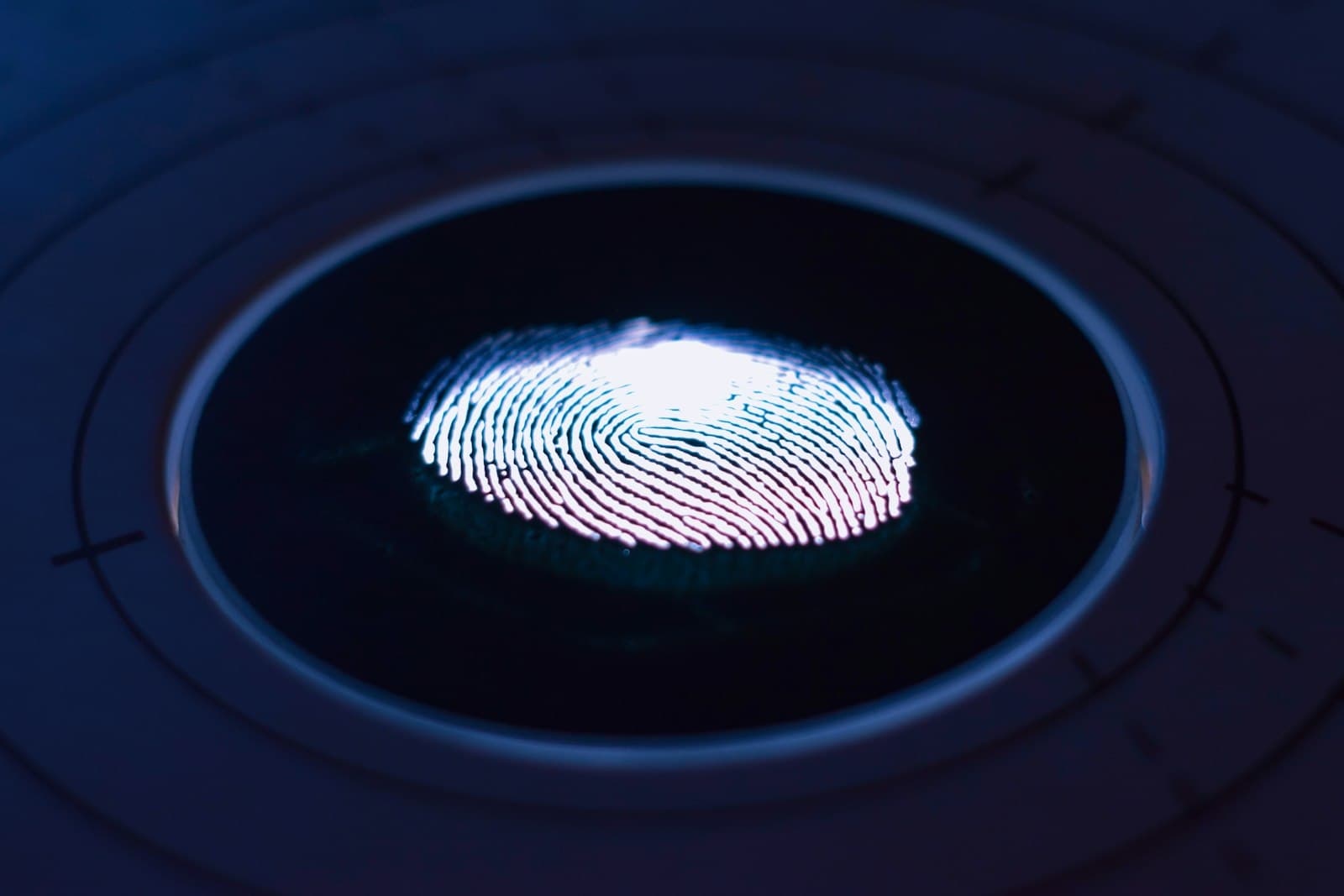 A glowing fingerprint on a biometric scanner, representing employee attendance tracking
