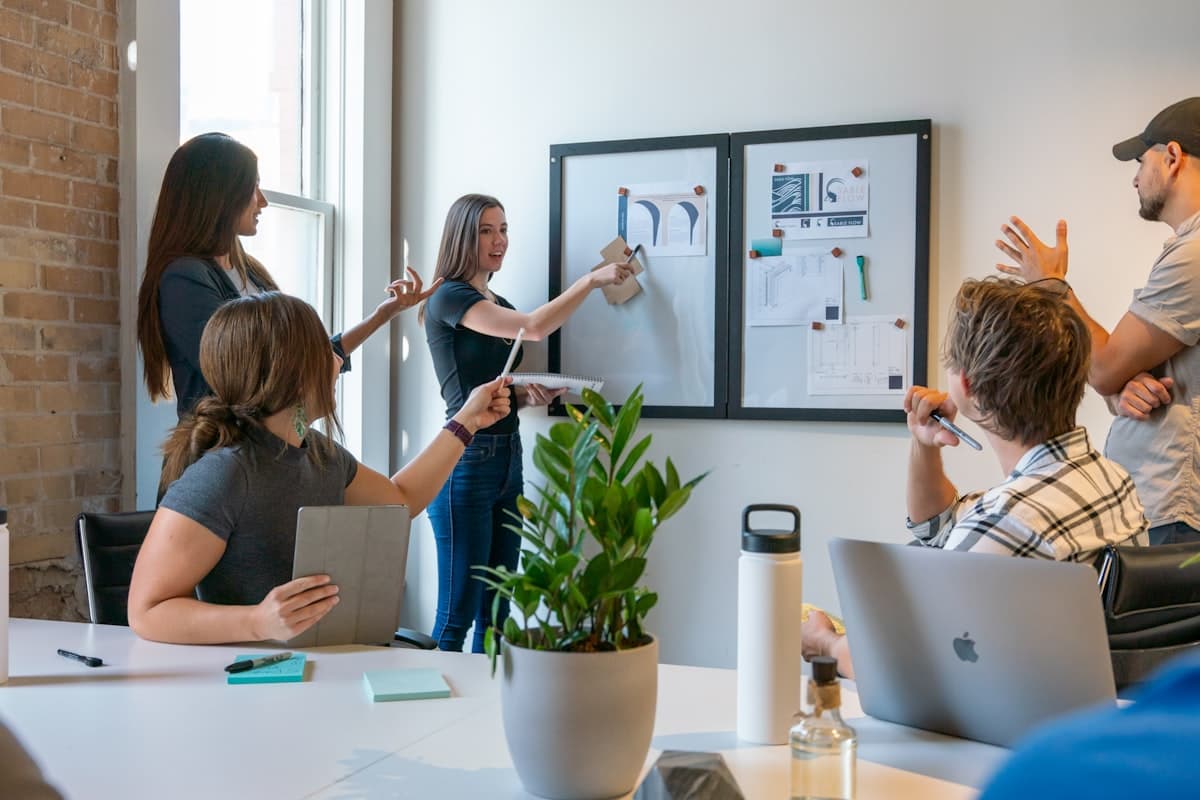 A team collaborating around a whiteboard in a modern office during a planning session
