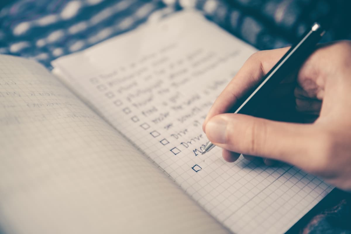 A printed checklist with a pen, used to review a software quote