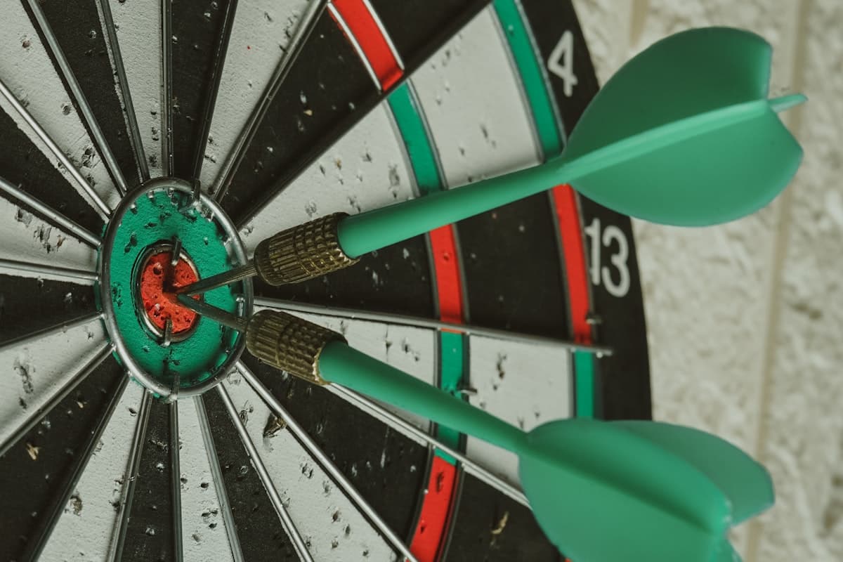 A dartboard with two darts landing in the bullseye, representing clear goals and focus